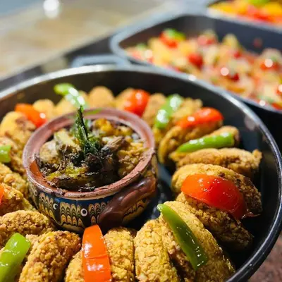 a plate of food with vegetables and dipping sauce at HVD Clubhotel Miramar - 24 Hours Ultra All Inclusive & Free Parking in Obzor