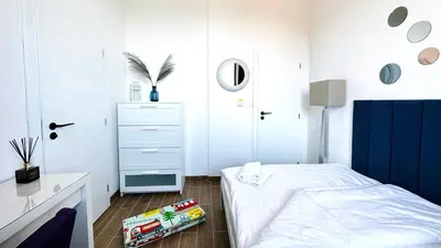 a small bedroom with a bed and a dresser at APARTELLO Modern Apartment - Garden of Eden in Sveti Vlas