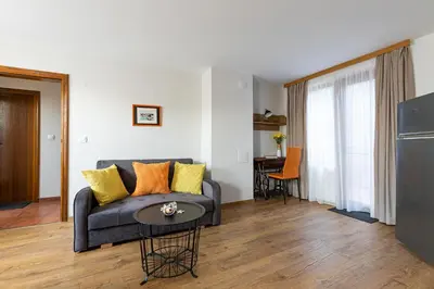 a living room with a couch and a table at Hotel Albatros Old Town in Sozopol