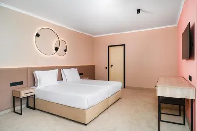a bedroom with a large bed and a television at Festa Panorama Hotel in Nesebar
