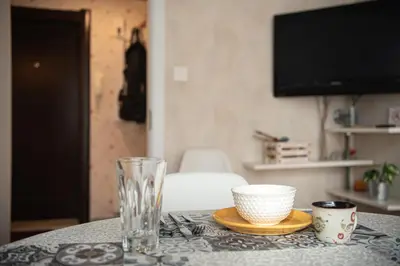 a table with a bowl and a glass on it at Photo Art apartment in Burgas City
