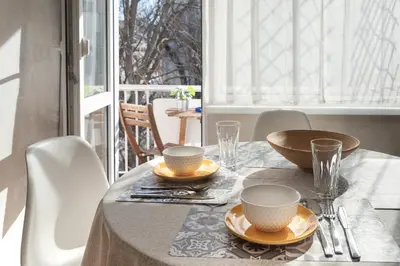 a table with two cups and plates on a table at Photo Art apartment in Burgas City