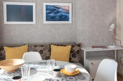 a dining room with a table and chairs at Photo Art apartment in Burgas City