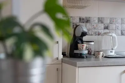 a kitchen counter with a coffee maker and cups at Photo Art apartment in Burgas City