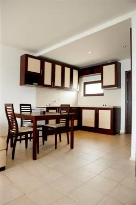 a dining room with a wooden table and chairs at Apartments 