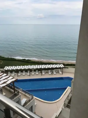 a view of the ocean from the balcony of a resort at By The Cliffs apartments in Byala