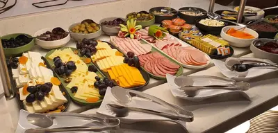 a buffet with many different types of cheese and meats at Hotel Bulgaria in Burgas City