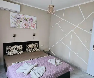a bedroom with a bed with two towels on it at GG Garden Deluxe in Chernomorets