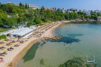 an aerial view of a beach with chairs and umbrellas at GG Garden Deluxe in Chernomorets
