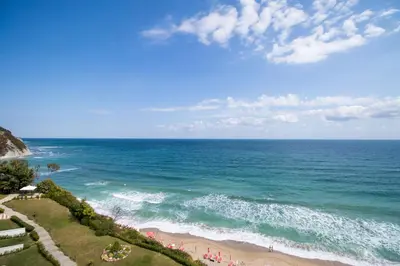 a view of the ocean with people on the beach at Penthouse at White Cliffs in Byala