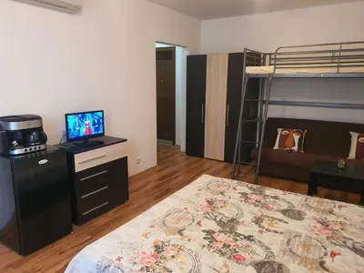 a room with a bed and a tv and a bunk bed at Apartments Paskalina in Byala