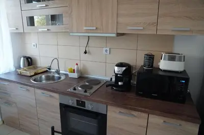 a small kitchen with a microwave and a sink at Apartments Paskalina in Byala