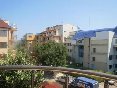 a view of a city from a balcony with buildings at Family Hotel Golden Lion in Primorsko