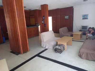 a cat laying on the floor in a living room at хотел Централ in Sozopol