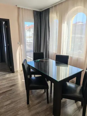 a dining room table with chairs and a glass table at Palma in Burgas City