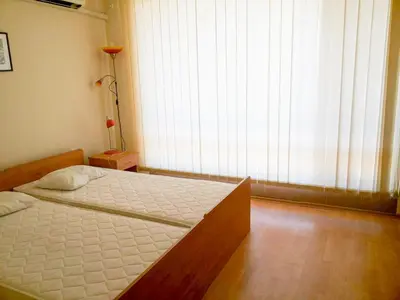 a bedroom with a bed and a large window at Nessebar Fort Club Apartment 226 in Sunny Beach