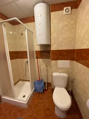 a small bathroom with a toilet and a shower at Nessebar Fort Club Apartment 226 in Sunny Beach