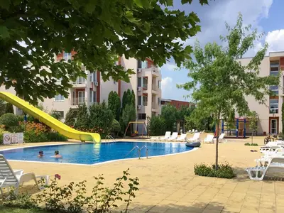 a swimming pool with a slide in a building at Nessebar Fort Club Apartment 226 in Sunny Beach