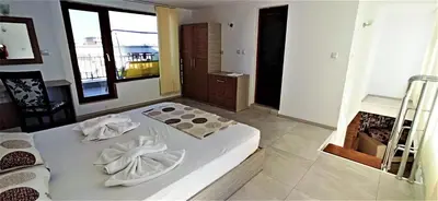 a bedroom with a bed with towels on it at Diamond Palace in Sunny Beach