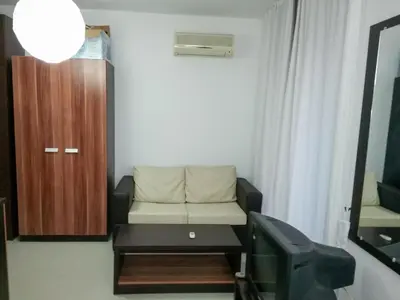 a small living room with a couch and a tv at Rainbow 3 Apartment-studio 223 in Sunny Beach