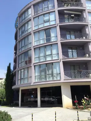 a tall building with balconies and tables at Rainbow 3 Apartment-studio 223 in Sunny Beach