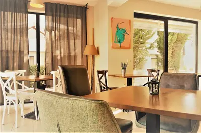a dining room with tables and chairs at New Line Village Apartments in Sunny Beach