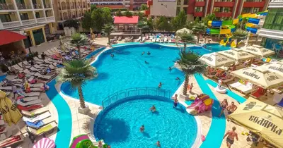 an overhead view of a large swimming pool with palm trees at Planeta Hotel & Aquapark FREE Beach Access - ULTRA All Inclusive in Sunny Beach