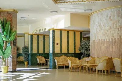 a lobby with chairs and tables in a building at Planeta Hotel & Aquapark FREE Beach Access - ULTRA All Inclusive in Sunny Beach