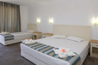 a hotel room with two beds with flowers on them at Mena Palace Hotel - All Inclusive in Sunny Beach