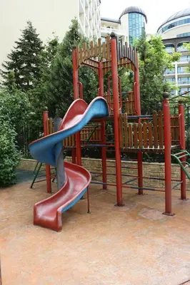 a playground with a blue and red slide at Mena Palace Hotel - All Inclusive in Sunny Beach