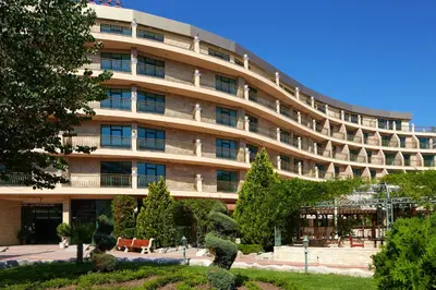 a large building with a statue in front of it at Mena Palace Hotel - All Inclusive in Sunny Beach