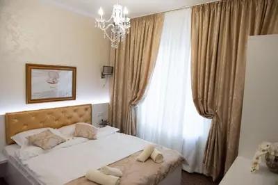 a bedroom with a bed with two towels on it at Golden House in Varna City