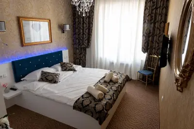 a hotel room with a bed with two teddy bears on it at Golden House in Varna City