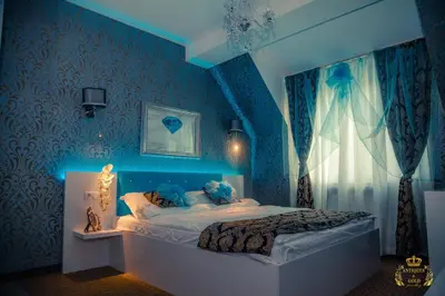 a blue bedroom with a large bed in a room at Golden House in Varna City