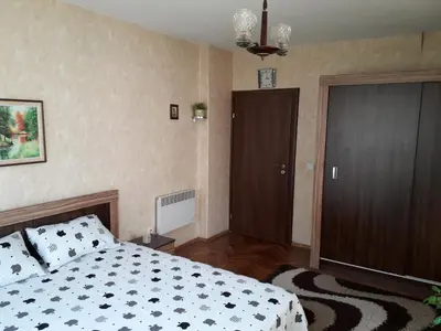 a bedroom with a bed and a door in it at Family style, main street, 20 minutes from the sea in Burgas City