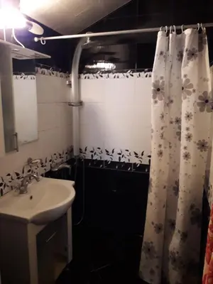 a bathroom with a sink and a shower curtain at Family style, main street, 20 minutes from the sea in Burgas City