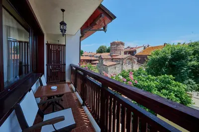 a balcony with a table and a view of a city at Hotel Saint John Baptist Nessebar in Nesebar