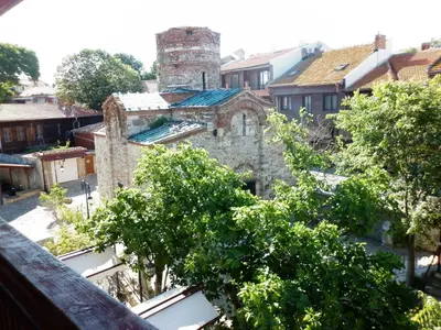an old building with a tower in a city at Hotel Saint John Baptist Nessebar in Nesebar