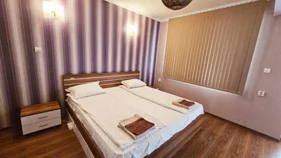 a bedroom with a large bed in a room at Green House Apartment in Burgas City