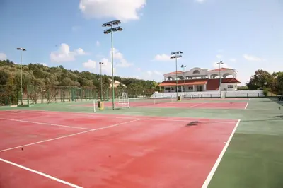 a tennis court with two tennis courts at Duni Pelican Hotel - All Inclusive in Sozopol