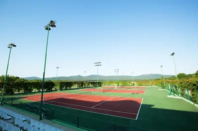 a tennis court with lights on top of it at Duni Marina Beach Hotel - All Inclusive in Sozopol