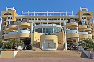 a large building with a statue in front of it at Duni Marina Beach Hotel - All Inclusive in Sozopol