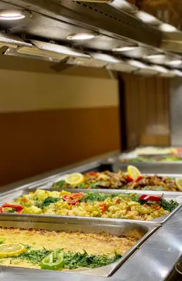 a row of trays filled with different types of food at Duni Marina Royal Palace Hotel - Ultra All Inclusive in Sozopol