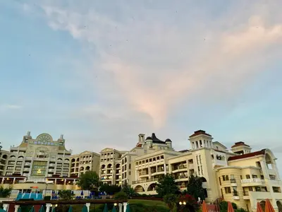 a large apartment building with a cloudy sky in the background at Duni Marina Royal Palace Hotel - Ultra All Inclusive in Sozopol