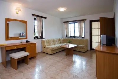 a living room with a couch and a mirror at Duni Holiday Village - All Inclusive in Sozopol