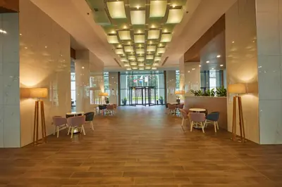 a lobby with chairs and tables in a building at Secrets Sunny Beach Resort and Spa - Premium All Inclusive - Adults Only in Sunny Beach
