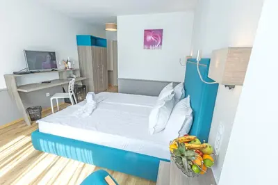 a bedroom with a bed with a bowl of fruit at BSA Boulevard Boutique in Sunny Beach