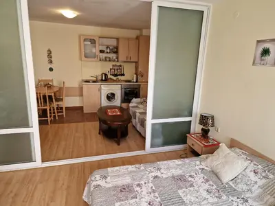 a living room with a bed and a kitchen at Słoneczny Brzeg Green Fort Noks Studio in Sunny Beach