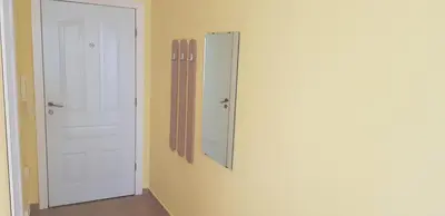 a room with a door and a mirror on the wall at Słoneczny Brzeg Green Fort Noks Studio in Sunny Beach