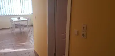 a door leading to a room with a table and a dining room at Słoneczny Brzeg Green Fort Noks Studio in Sunny Beach